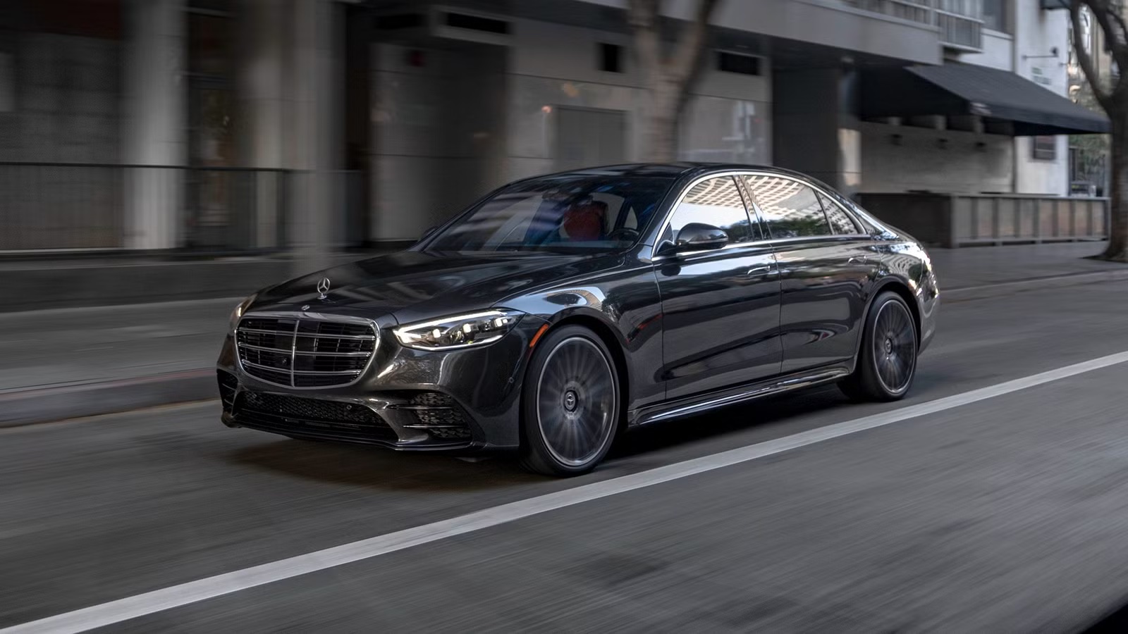 Black Mercedes-Benz S-Class luxury sedan in motion